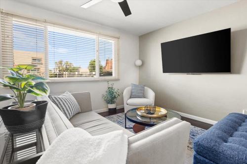 a living room with a couch and a flat screen tv at Old Town Elegance in Scottsdale