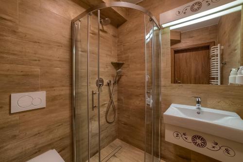a bathroom with a shower and a sink at Hotel Górski in Białka Tatrzanska