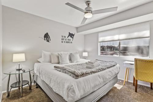a white bedroom with a large bed and a window at High Pines Abode in Flagstaff
