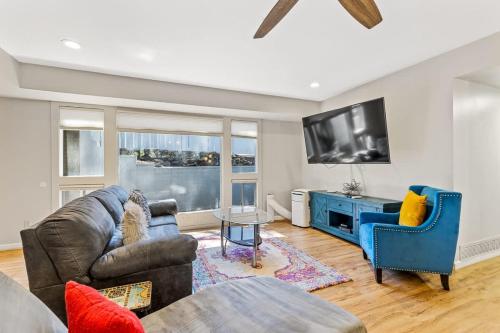 a living room with a couch and a tv at High Pines Abode in Flagstaff
