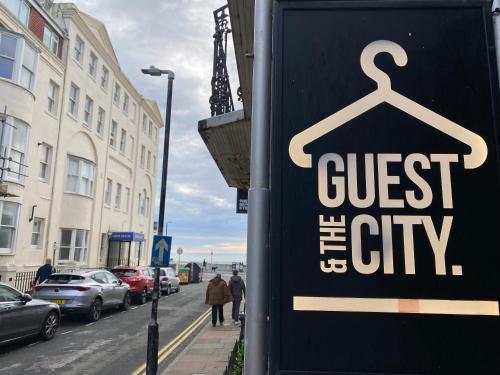 a sign for a store on a city street at Guest And The City in Brighton & Hove
