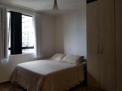 a bedroom with a bed and a window at Flat Novo1 - Café, Cama Queen, Ar, Estac e Internet in Barueri