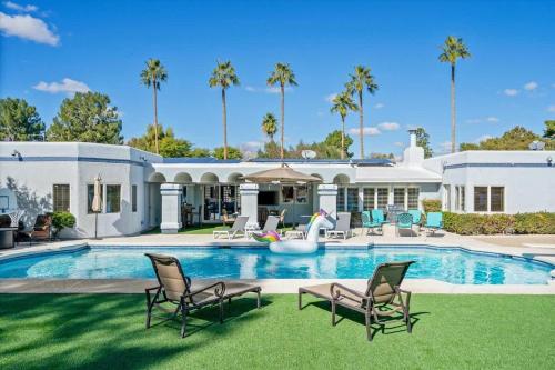 a large white house with a swimming pool at Live Blissfully in Phoenix
