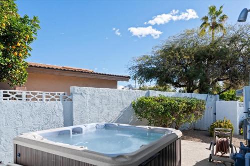 a hot tub in a yard next to a fence at Live Blissfully in Phoenix