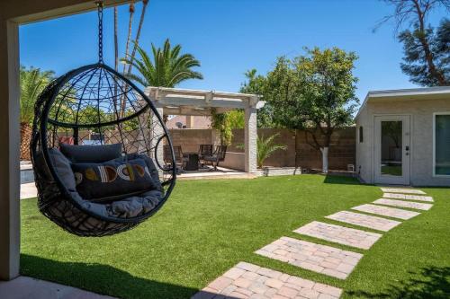 a hanging hammock in a yard with grass at The Seaside Bohemian in Chandler