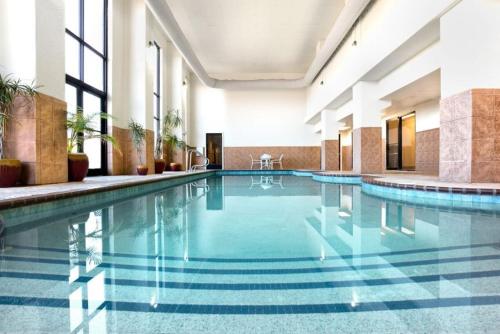 a large swimming pool in a hotel lobby at Grand Plaza Hotel & Conference Center in Branson