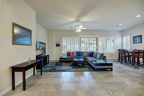 a living room with a couch and a table at Sun City Fun - Alice Lodging in Indio