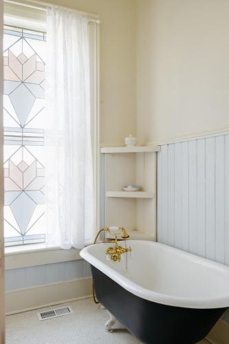 a bath tub in a bathroom with a window at The Mulberry Inn -An Historic Bed and Breakfast in St. George