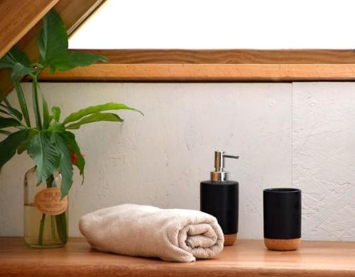 a bathroom counter with a towel and a faucet at Le Fare de la Baleine in Punaauia