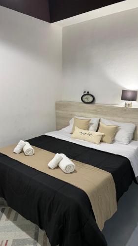 a bedroom with a large bed with towels on it at EzeApart in Ezeiza