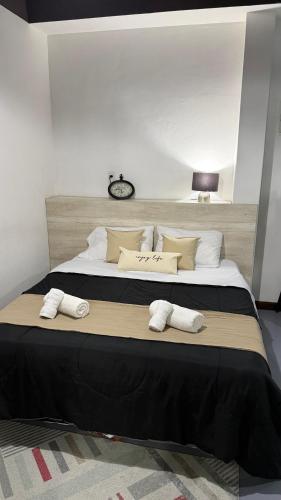 a bedroom with a large bed with two towels on it at EzeApart in Ezeiza