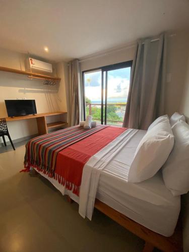 a bedroom with a large bed with a large window at Villa Visgo Itacaré in Itacaré