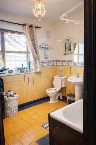 a bathroom with a toilet and a sink and a tub at Gra accommodations athy in Athy