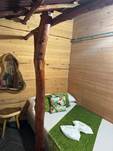 a room with a bed in a log cabin at Chiki luki in Playa Blanca