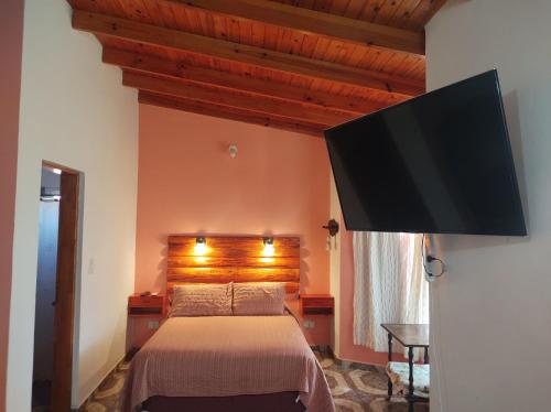a bedroom with a bed and a flat screen tv at Las Tres Reinas B in Colorado River