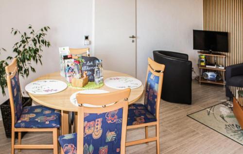 a dining room table with four chairs and a table at Beautiful Apartment In Reifferscheid in Reifferscheid
