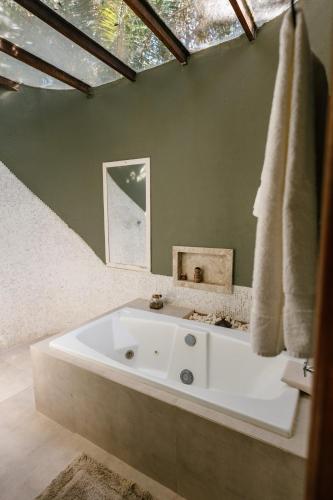 a white bath tub in a bathroom with a window at Casa de Madeira - Sao Jorge GO in Sao Jorge