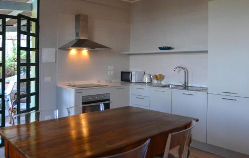 a kitchen with a wooden table and a counter top at Case Sparse San Savino in San Savino