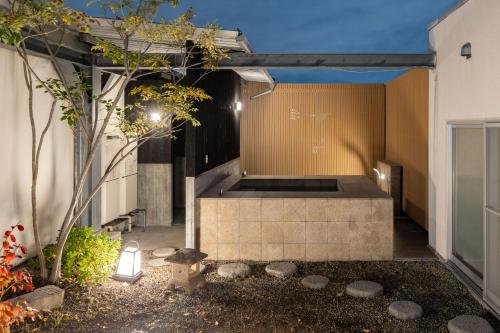 an external view of a house with a courtyard at Bijou Suites AI PREMIUM in Osaka