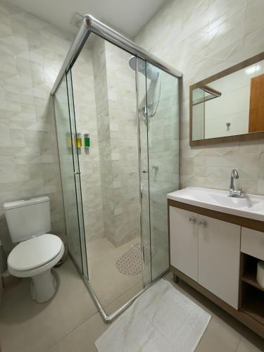 a bathroom with a shower and a toilet and a sink at Sobrado NOVO próximo BR 290 in São Gabriel