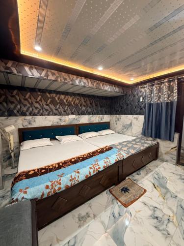 a large bed in a room with marble floors at Samriddhi UrbanStay in Ayodhya