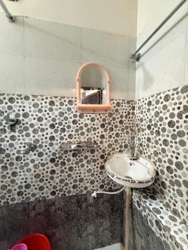 a bathroom with a sink and a mirror at Samriddhi UrbanStay in Ayodhya