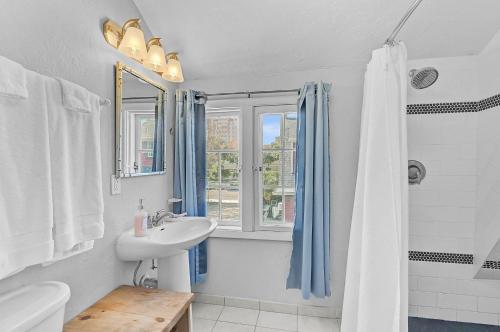 a white bathroom with a sink and a shower at The Reserve Retreat in Sarasota