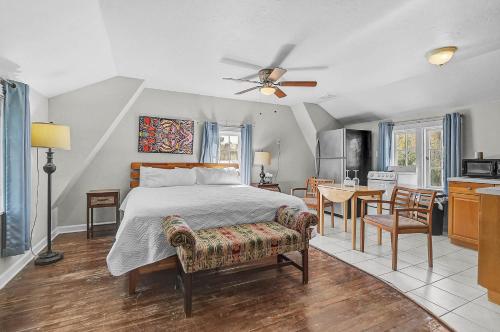 a bedroom with a bed and a table and a kitchen at The Reserve Retreat in Sarasota