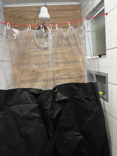 apron hanging on a clothesline in a bathroom at Pesqueiro & Pousada Beatriz in Piedade