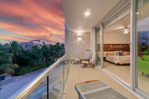 a room with a balcony with a view of a bedroom at Akumal Cielo Seven Ocean View Pools Beach Access in Akumal