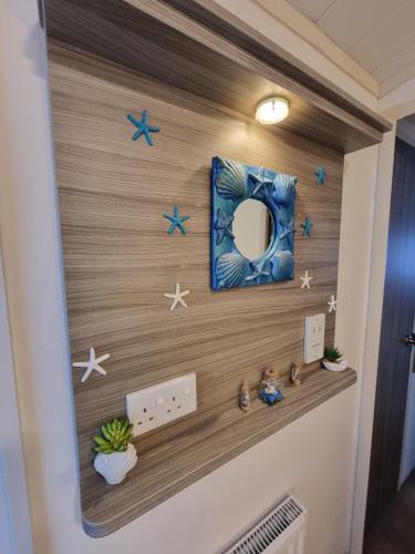 a hallway with a wall with stars and a mirror at Island Escape Sandown in Sandown