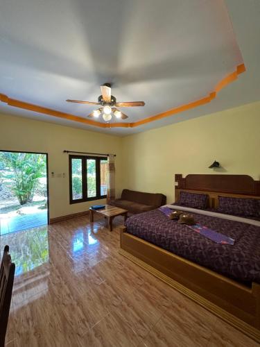 a bedroom with a bed and a ceiling fan at Phu Lanta Life Resort in Ko Lanta