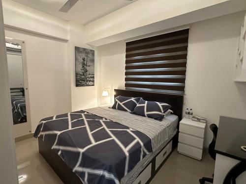 a bedroom with a large bed and a desk at Oval View Residencies By C in Colombo