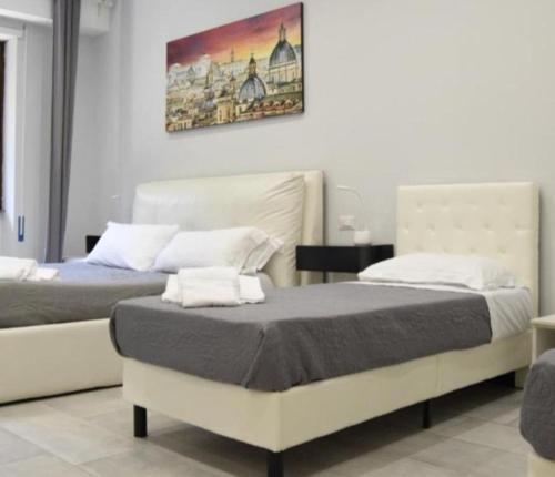 a bedroom with two beds and a painting on the wall at Hotel La Posada de los Volcanes - ALTARA in Arequipa
