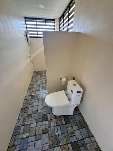 a bathroom with a white toilet in a room at O Zen Resort in Ko Man Nai