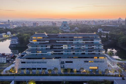 a large building with a city in the background at Espacio Nagoya Castle, The Leading Hotels of the World "LHW" in Nagoya