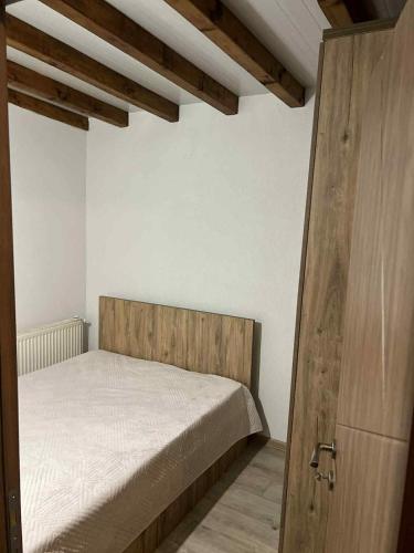 a bedroom with a bed and a wooden door at Vila Davidoski in Mavrovo