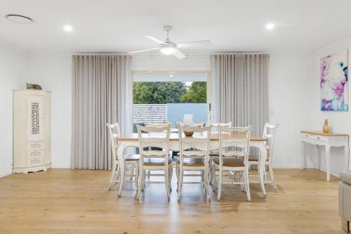a dining room with a table and chairs at Coastal House in Gold Coast