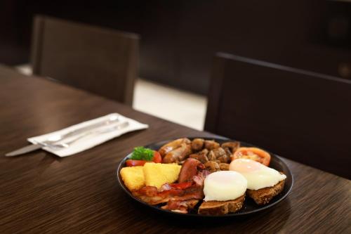 a plate of food on a wooden table at Swiss-Belhotel Napier in Napier