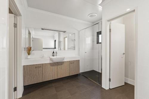 a bathroom with a sink and a mirror at Hartzell One Seven - Private - Family Friendly in Wilyabrup