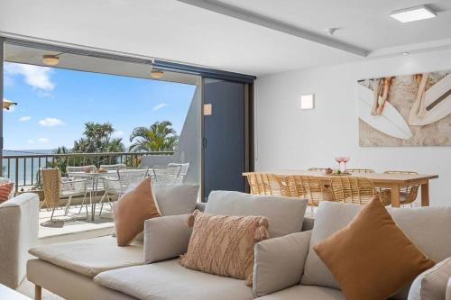 a living room with a couch and a balcony at The Rocks Resort Unit 2C in Gold Coast