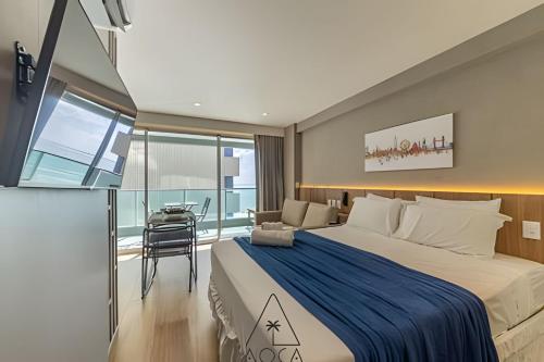 a bedroom with a large bed and a table at RN Studio Premium – Your Seaside Retreat in Maceió