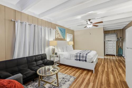 a living room with a bed and a couch at Spacious comfortable Studio Unit in Tallahassee