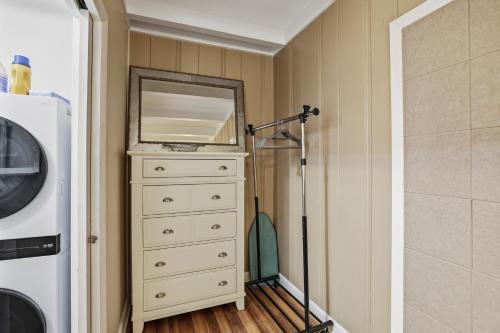 a bathroom with a dresser and a mirror at Spacious comfortable Studio Unit in Tallahassee