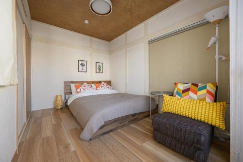a bedroom with a bed and a chair at Direct Haneda Access &Onsen 1-min Walk SAMURAI STAY ZEN in Tokyo
