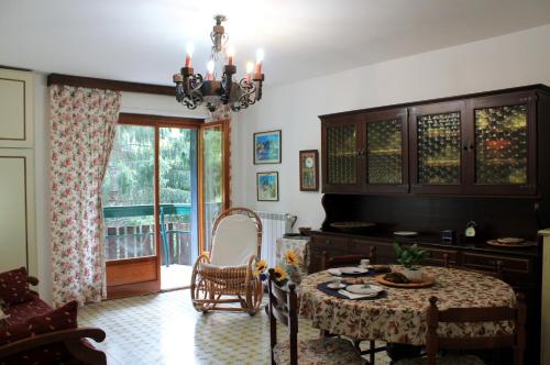 a living room with a table and a balcony at Casa Rivalta by Holiday World in Limone Piemonte