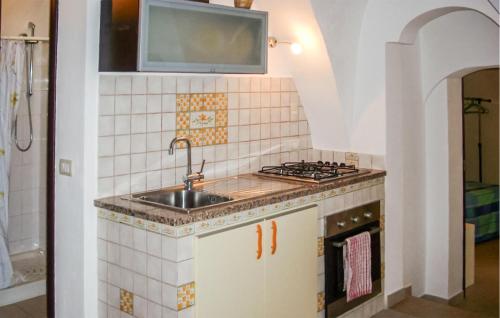 a kitchen with a sink and a stove at Casa Herea in Ragusa