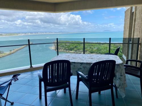 a table and chairs on a balcony with a view of the ocean at High Level with Ocean Views Everywhere in Buddina