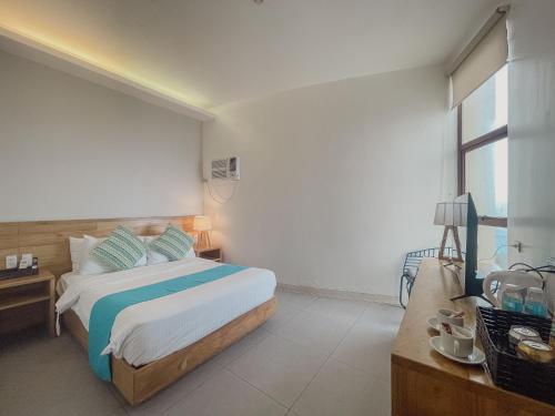 a bedroom with a bed and a large window at Bay's Inn Resort in Baler