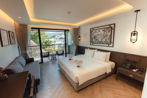 a bedroom with a bed with a dog on it at Peach Hill Resort - SHA Extra Plus in Kata Beach